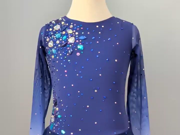 A blue figure skating dress on a dress form